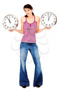 Young woman holding clocks and posing isolated over white
