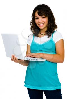 Beautiful teenage girl using a laptop and smiling isolated over white