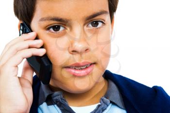 Boy talking on a mobile phone isolated over white