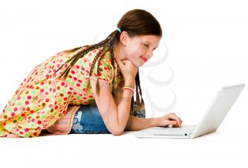 Happy girl using a laptop isolated over white