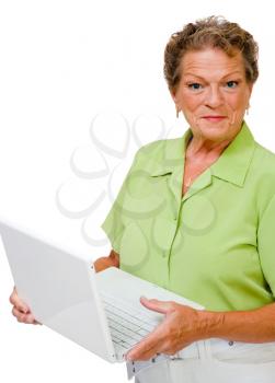 Smiling woman using a laptop and posing isolated over white