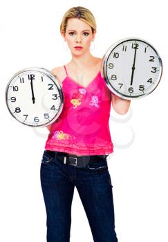 Beautiful woman holding clocks and posing isolated over white