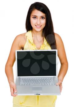 Happy woman showing a laptop and posing isolated over white