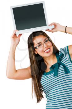 Gorgeous woman holding a laptop and smiling isolated over white