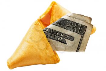 Twenty dollar bill in a fortune cookie isolated over white