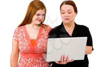 Close-up of women using a laptop and smiling isolated over white