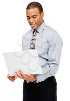 Confident businessman using a laptop and smiling isolated over white