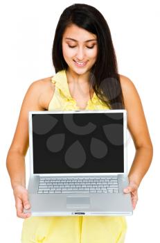 Confident woman using a laptop and posing isolated over white
