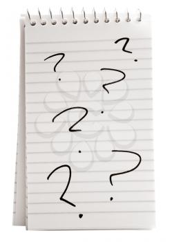 Six question marks on a spiral notebook isolated over white
