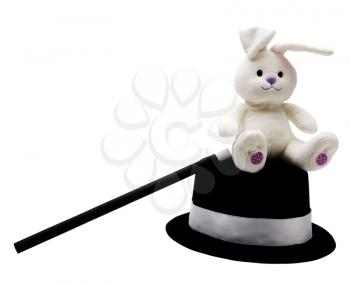 Stuffed rabbit with magic wand and top hat isolated over white