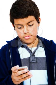 Caucasian boy listening to music on an MP3 player isolated over white