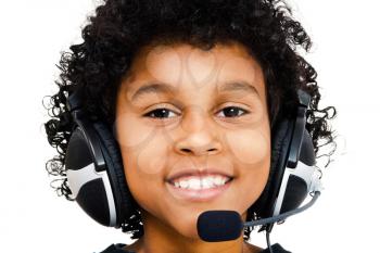 Portrait of a boy wearing a headset and smiling isolated over white