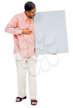 Confident mature man showing a placard isolated over white