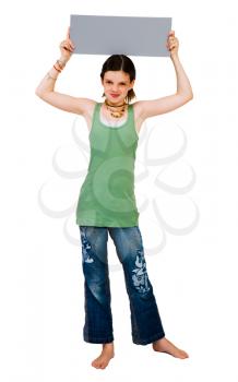 Happy girl showing a placard and posing isolated over white
