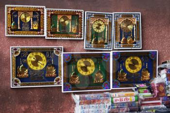 Books with clocks at a market stall, Delhi, India