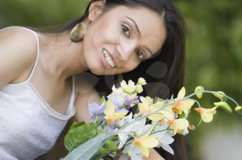 Portrait of a teenage girl with bouquet of flowers