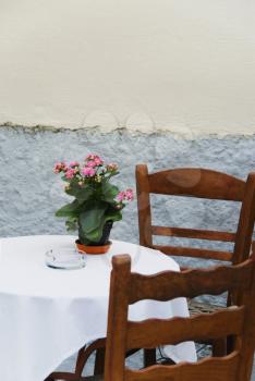 Table and chairs at a sidewalk cafe, Athens, Greece