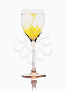 Yellow color streaks with water in a wine glass