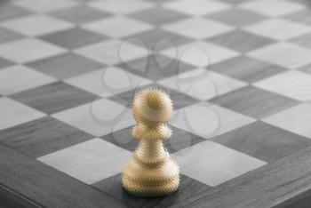 Close-up of a pawn and a chessboard