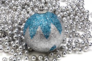Close-up of a silver and blue bauble on string of silver beads