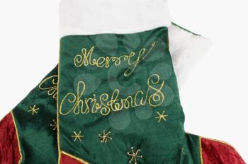 Merry Christmas text embroidered on a Christmas stocking