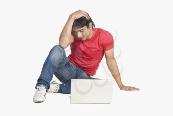 Man sitting in front of a laptop