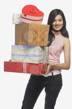 Woman holding gift boxes and smiling