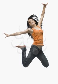 Young woman jumping against white background