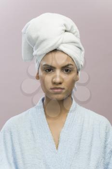 Portrait of a young woman with her head wrapped in a towel
