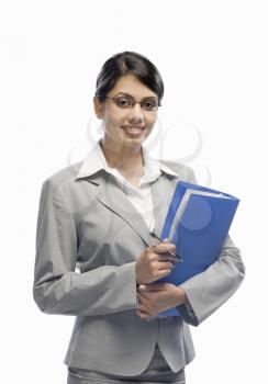 Portrait of a businesswoman holding a file and standing against a white background