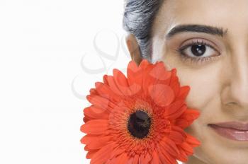 Portrait of a beautiful Indian fashion model with a flower