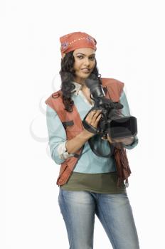 Portrait of a female videographer with video camera