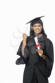 Portrait of a female graduate cheering with her diploma