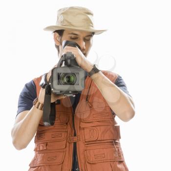 Young male videographer holding a videography camera