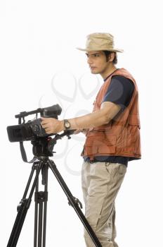 Young male videographer holding a videography camera