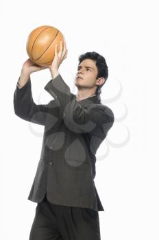 Businessman playing basket ball