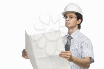 Male architect holding a blueprint