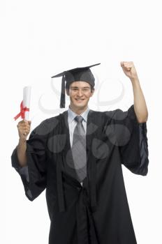 Portrait of a happy male graduate holding his diploma