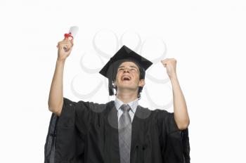 Happy male graduate holding his diploma