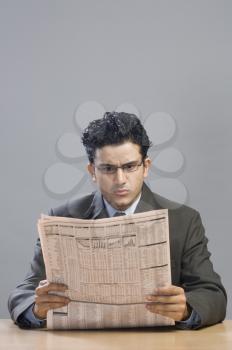 Businessman reading a financial newspaper