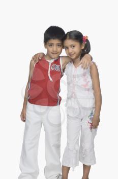 Portrait of a boy and his sister arm around