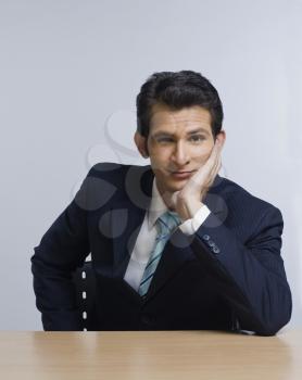 Portrait of a businessman sitting at a table