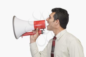 Close-up of a businessman announcing into a megaphone