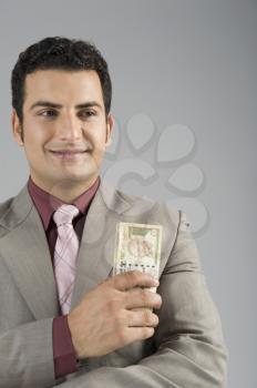 Businessman holding Indian five hundred rupee banknotes