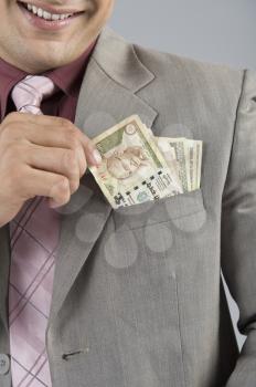 Businessman with Indian five hundred rupee banknotes in his pocket
