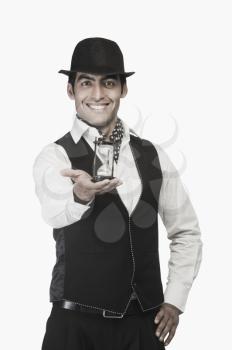 Businessman holding an hourglass and smiling