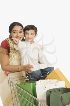 Woman with her son sitting on a shopping cart