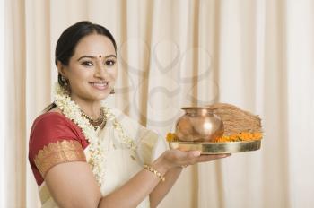 South Indian woman holding pooja thali