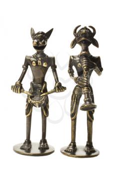 Close-up of two tribal figurines with traditional musical instrument