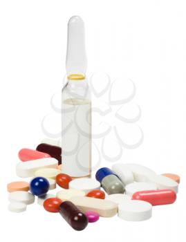 Close-up of assorted pills with a vial